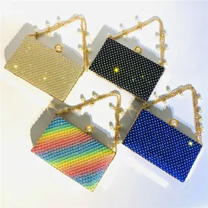 Closeup detail showing four sparkling rhinestone evening clutch bags with pearl chain straps.