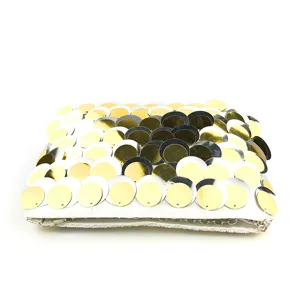 Detailed view of the gold and silver sequined evening clutch bag featuring shiny scale patterns.
