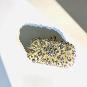 Exquisite rhinestone evening clutch bag with handcrafted beads, elegant metallic clasp design.
