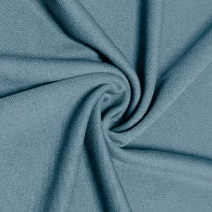 Close-up detail of blue-grey knitted fabric texture showing fine mesh and soft material feel.