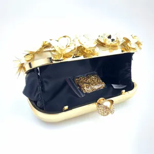 Detail view of the elegant evening clutch with shimmering sequins, gold frame, and pearl clasp.