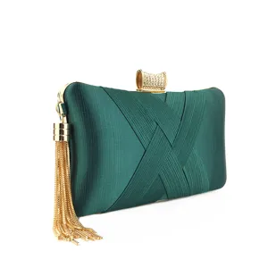 Dark green satin evening clutch bag with gold metallic tassel and sparkling rhinestone lock.