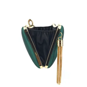 Close-up of dark green satin evening clutch featuring elegant gold metal frame and tassel.