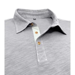 Detailed view of grey men's short sleeve business polo shirt collar and placket design.