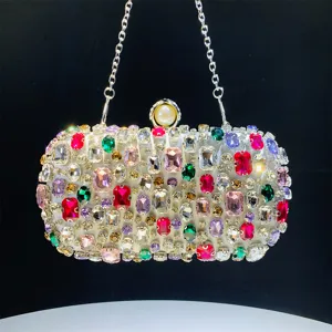 Detailed view of the sparkling rhinestone evening clutch bag with pearl clasp and chain strap.