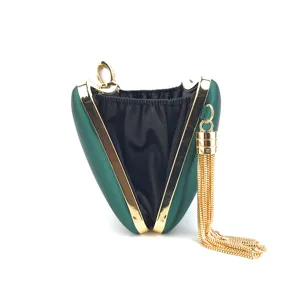Green satin evening clutch bag detail showing gold metal frame and elegant tassel pendant.