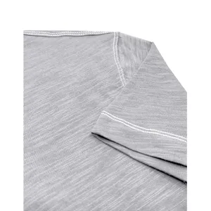 Detail view of gray cotton t-shirt shoulder seam and white stitching craft texture.