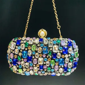 Detailed close-up of handmade full rhinestone evening clutch bag with colorful sparkly crystals.