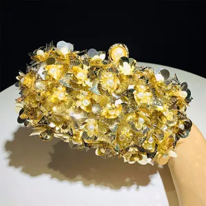 Detailed view of a stunning gold sequin floral evening clutch with pearl clasp for parties.