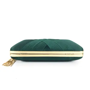 Green satin evening clutch bag with elegant gold metal frame and decorative tassel detail