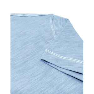 Close-up detail of light blue cotton mens t-shirt sleeve and shoulder seam texture design.