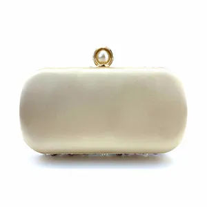Close-up of the elegant pearl clasp and satin texture on the luxury evening clutch.