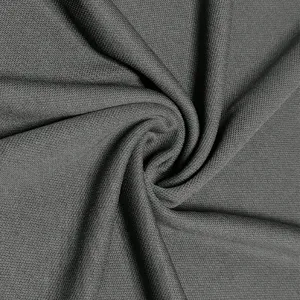 Close up view of the dark grey knitted fabric texture showing fine mesh and soft material.