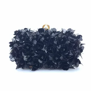Black sequin floral clutch bag detail, evening party purse with pearl clasp decoration.