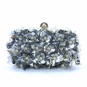 Detailed view of the silver sequin evening clutch, featuring exquisite floral bead embellishments.