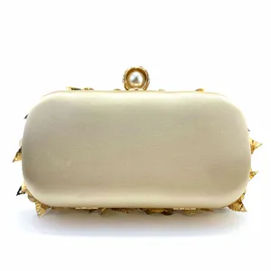 Elegant satin evening clutch bag with gold leaves and pearl clasp for women parties.