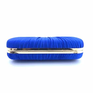 Detailed view of the blue pleated satin evening clutch bag featuring a shiny gold metal frame.