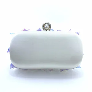 Close-up of white satin evening clutch bag featuring gradient sequins and pearl clasp detail.
