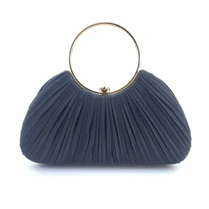 Black satin pleated evening clutch bag detail featuring luxury gold round metal handle for party.
