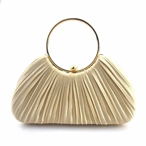 Detail of pleat satin evening bag with metal ring handle, elegant texture for party dress.
