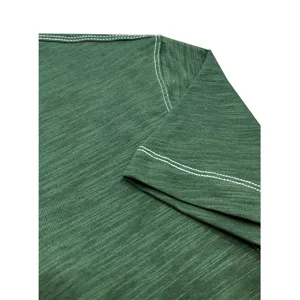 Close-up detail of green cotton t-shirt showing shoulder stitch and soft textured fabric.
