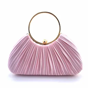 Pink satin pleated evening clutch bag with elegant gold round ring handle for party dress.