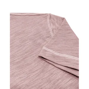 Close-up view of mens cotton t-shirt shoulder and sleeve showing fine white contrast stitching.