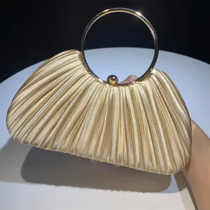 Pleated satin evening bag detail, elegant gold metal ring handle design for party dress.