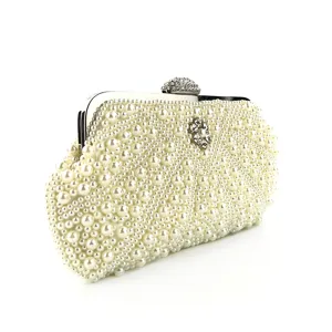 Pearl beaded evening clutch detail, metallic clasp with rhinestones, elegant bridal bag.