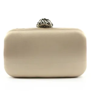 Elegant champagne satin evening clutch bag with beaded floral clasp detail, perfect for bridal.