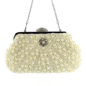 Elegant pearl evening clutch bag with rhinestone clasp and chain strap for parties and weddings.