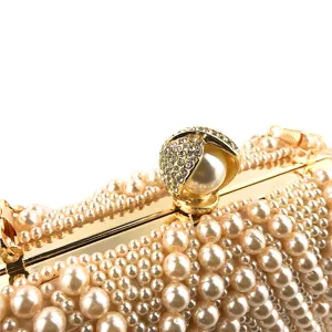 Pearl beaded clutch detail, handcrafted evening bag with rhinestone clasp and gold frame.