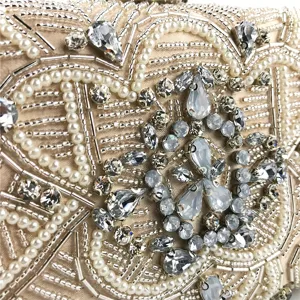Exquisite handmade beaded evening clutch bag detail showing intricate pearls and rhinestones design.