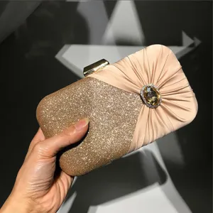 Elegant women evening clutch bag detail, glitter and pleated satin with diamond buckle.