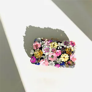Handmade colorful floral beaded clutch evening bag detail close-up view sparkling design.