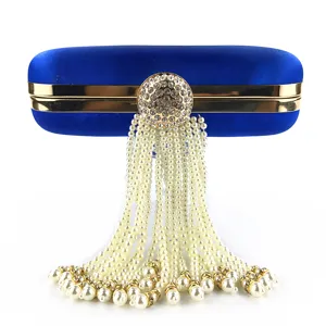 Royal blue satin evening clutch detail showcasing the elegant rhinestone clasp and pearl tassels.