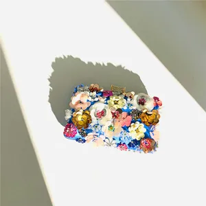 Exquisite handmade floral beaded evening clutch detail shot, vibrant sequin decoration.