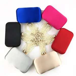 Detailed view of colorful satin evening clutch bags with multi-strand pearl straps.