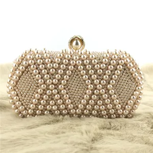 Exquisite beaded evening clutch detail, featuring elegant faux pearls and gold clasp.