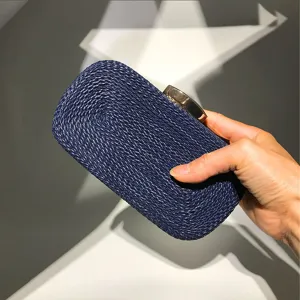 Handcrafted woven evening clutch bag in dark blue with chic gold clasp for women style detail.