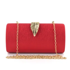Elegant red evening clutch bag with gold leaf clasp and chain strap for women parties.