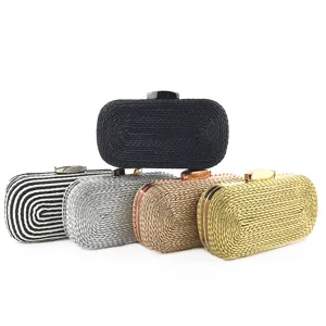 Detailed view of the woven clutch bag featuring metallic clasp and stylish design options.