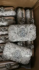 Detailed view of handmade beaded evening clutch bag with exquisite rhinestones and metal frame.