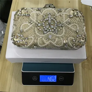 Exquisite handmade beaded evening clutch bag detail showing sparkling crystals and pearls.