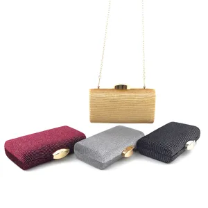 Detailed view of women evening clutch bag with metallic lock and velvet sequin fabric design.