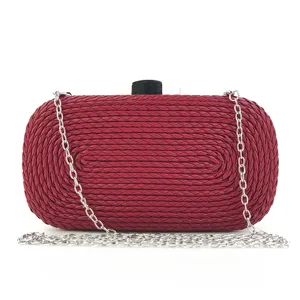 Elegant red woven clutch bag with silver chain strap for evening parties and weddings.