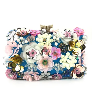 Detailed view of handmade colorful sequin flower evening clutch with sparkling rhinestone clasp.