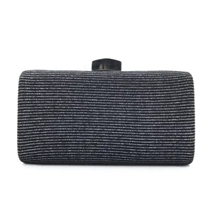 Detailed view of the sparkling glitter fabric evening clutch bag with elegant clasp closure.