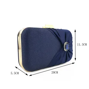 Navy blue satin evening clutch bag with gold frame and sparkling crystal gem buckle.