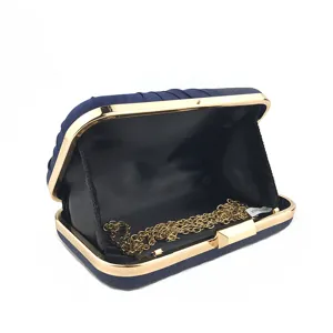 Dark blue pleated evening clutch bag with gold tone metal frame and chain strap detail.